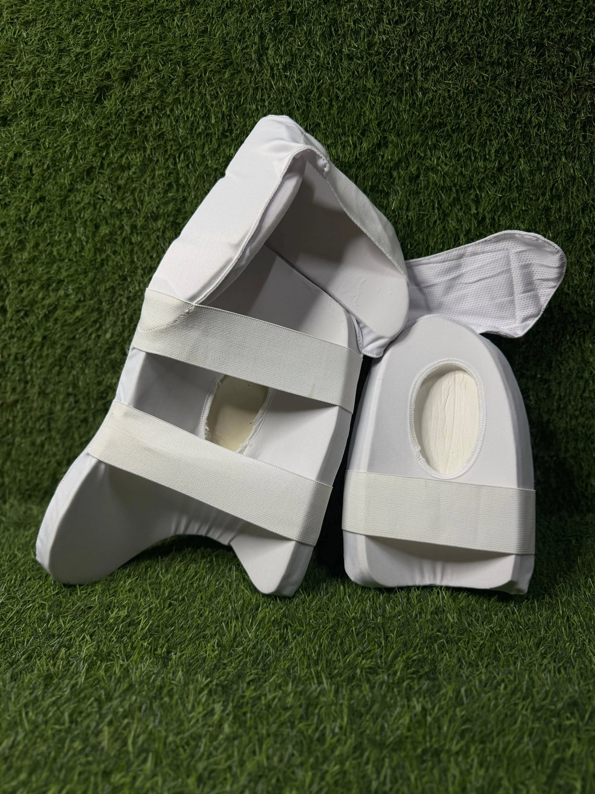 A pair of white cricket thigh pad with Aero P1 Branding